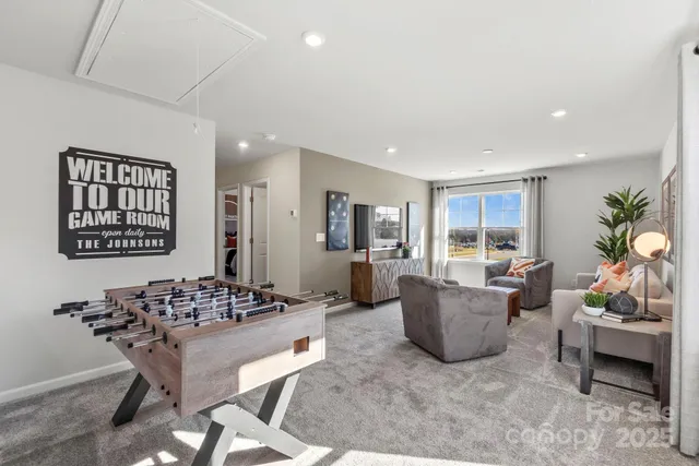 a living room with furniture a window and a table