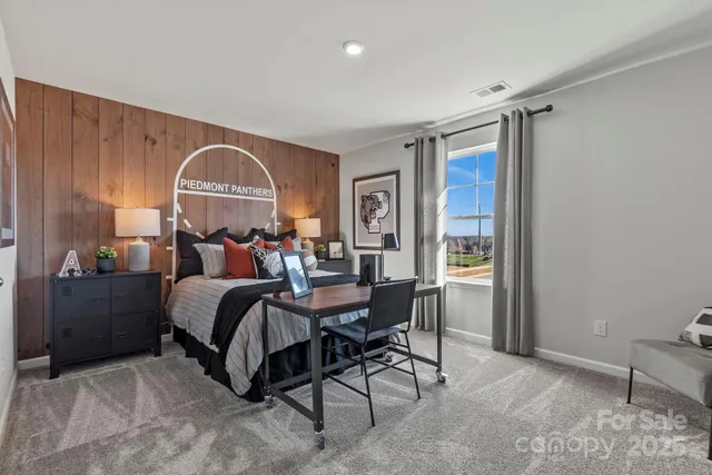 a bed room with a bed and a chair