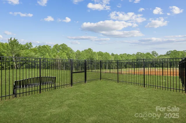 a view of a wrought iron fences in front of houses