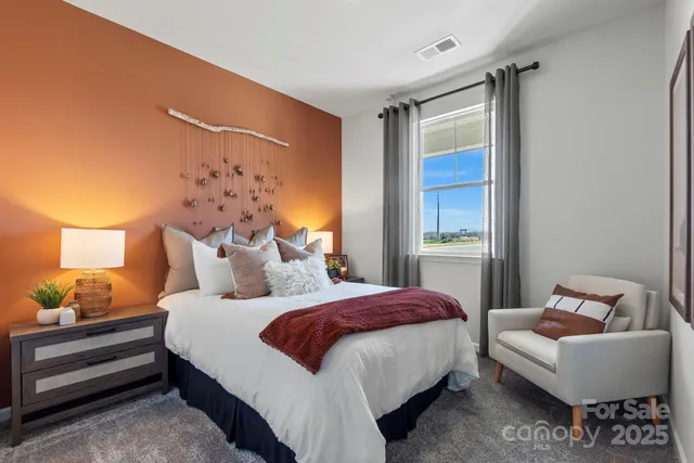 a bedroom with bed and a window