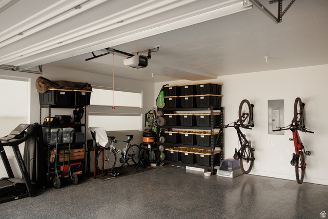 629 Spring Lily Drive St. George, UT 84790 - Photo 47 of 50 Spacious garage featuring a durable epoxy floor, multiple transom windows, an automatic garage door opener, and extensive built-in shelving for organized storage