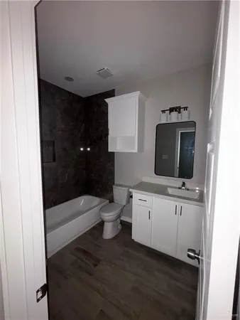 a bathroom with a toilet a sink and bathtub