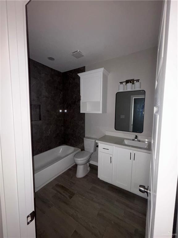 3186 Briggs Road, Unit 2 Weslaco, TX 78596 - Photo 12 of 19 a bathroom with a toilet a sink and bathtub