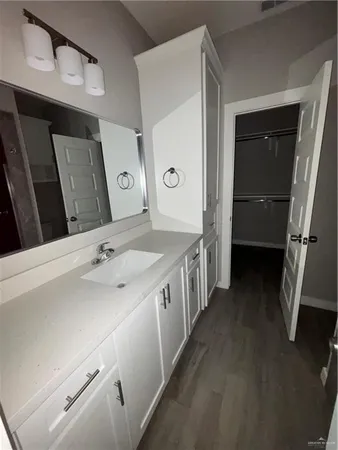 a bathroom with a sink a toilet and mirror