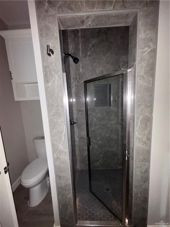 3186 Briggs Road, Unit 2 Weslaco, TX 78596 - Photo 17 of 19 a bathroom with a shower and toilet