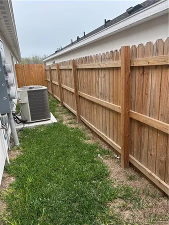 a view of backyard with wooden fence