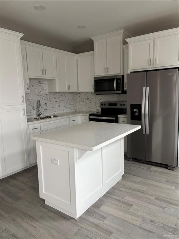 3186 Briggs Road, Unit 2 Weslaco, TX 78596 - Photo 6 of 19 a kitchen with stainless steel appliances white cabinets and a refrigerator