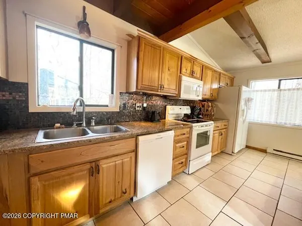 a kitchen with a sink cabinets and window