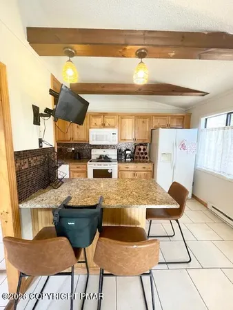 a view of a dining room with furniture and a potted plant
