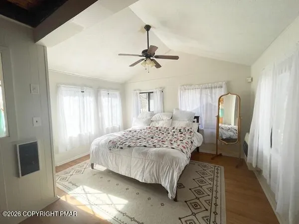 a spacious bedroom with a bed and a dresser