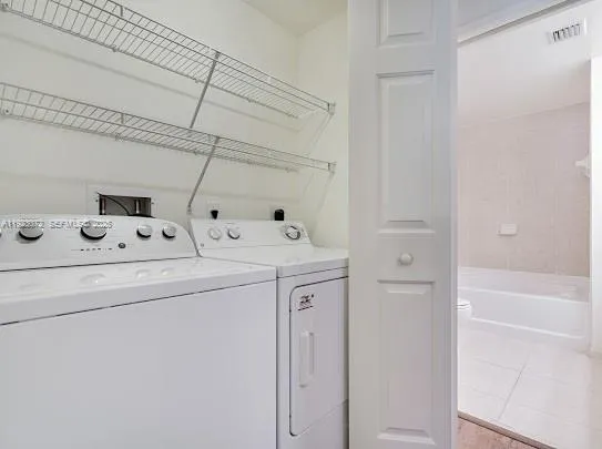 a utility room with dryer and washer