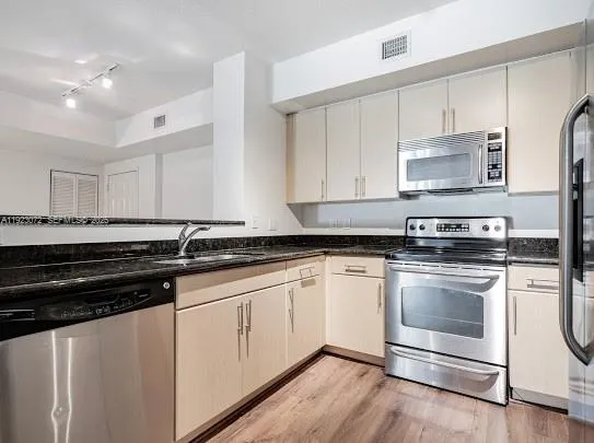 a kitchen with a refrigerator and a stove