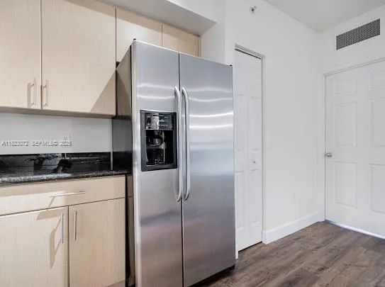 a kitchen with stainless steel appliances granite countertop a sink stove and wooden floor
