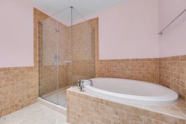 a bathroom with a granite countertop sink a toilet and shower