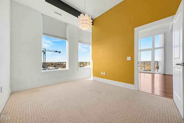 a view of a door and a room with wooden floor
