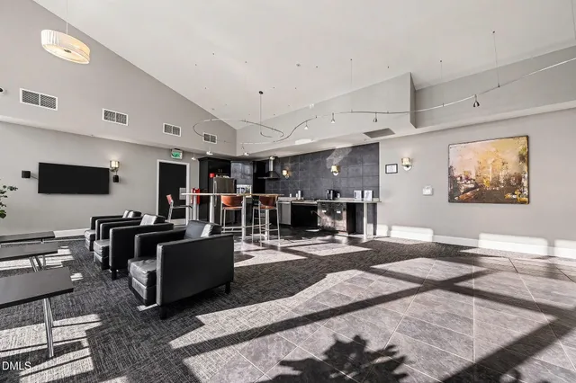 a living room with furniture a dining table and kitchen view