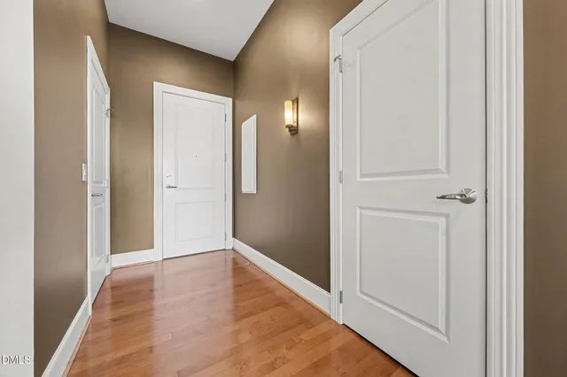 a view of a hallway with wooden floor