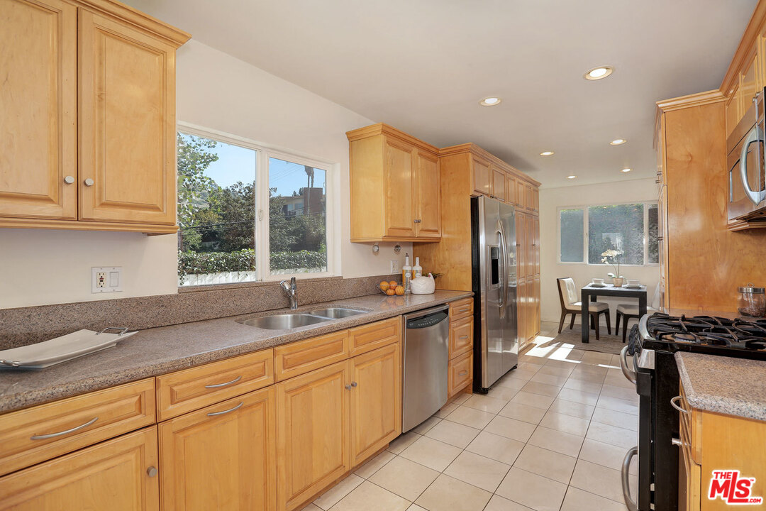 3838 Crestview Road Culver City, CA 90232 - Photo 13 of 29 a kitchen with stainless steel appliances granite countertop a sink and cabinets