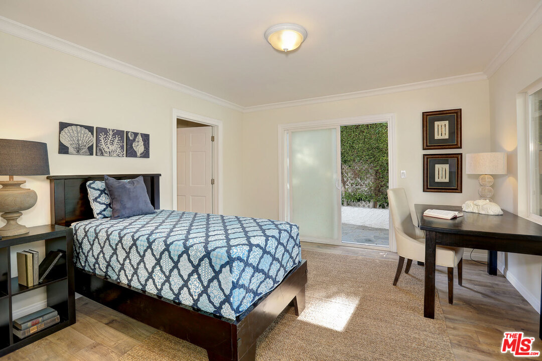3838 Crestview Road Culver City, CA 90232 - Photo 17 of 29 a bedroom with a bed and a table in it with window