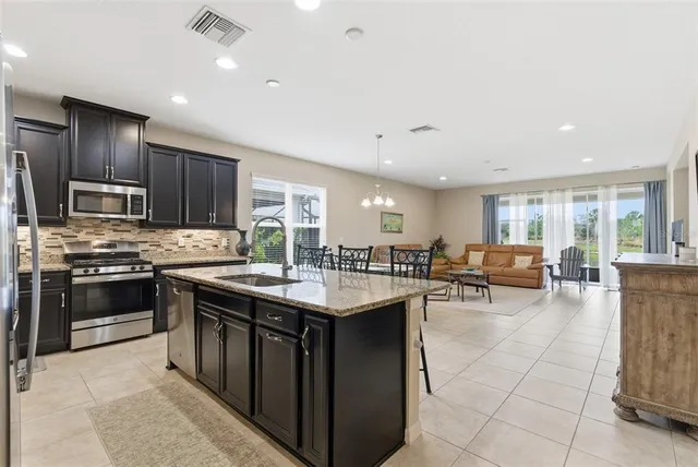 a spacious bedroom with a bed and a refrigerator