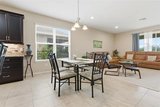 a bathroom with a tub a double vanity sink and a mirror