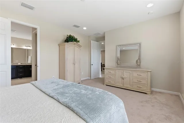 a bathroom with a granite countertop sink a toilet and a bathtub