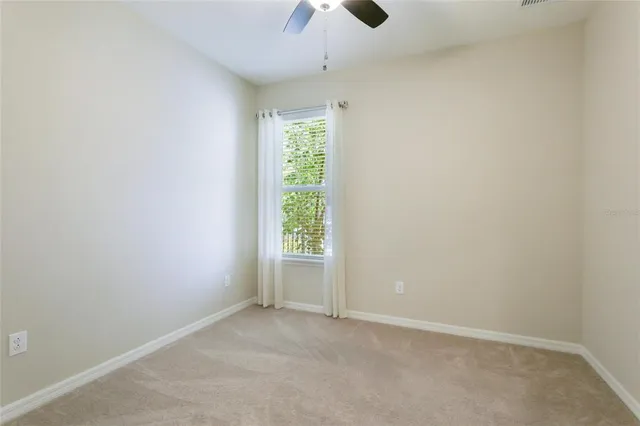 a view of a big house with a big yard and large trees