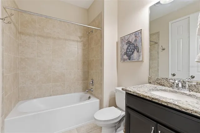 a front view of a house with a garden and yard