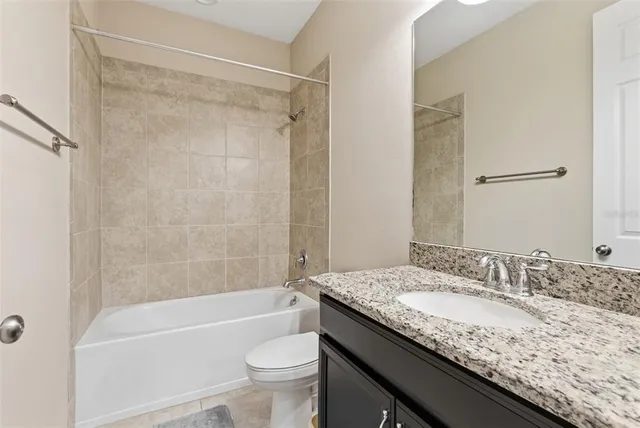 an aerial view of residential houses with outdoor space and ocean view