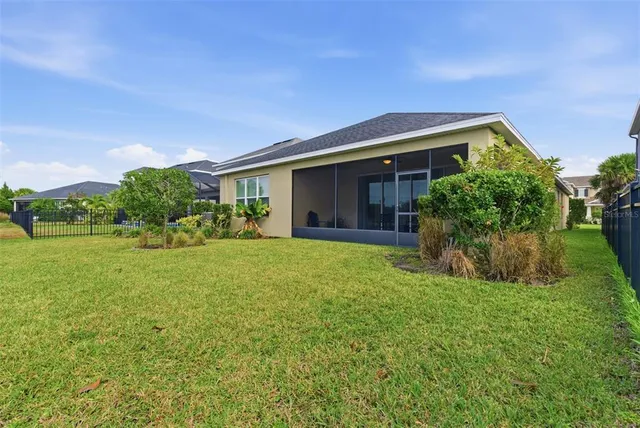 a view of a city with lawn chairs and large trees