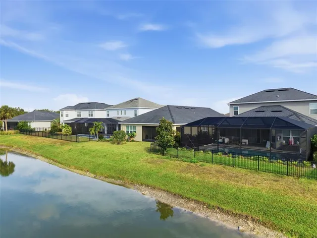 an aerial view of a house with a yard and lake view
