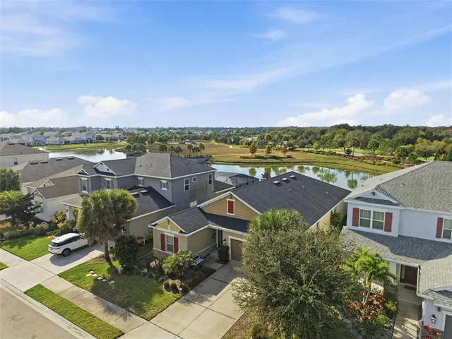 an aerial view of a swimming pool with outdoor seating