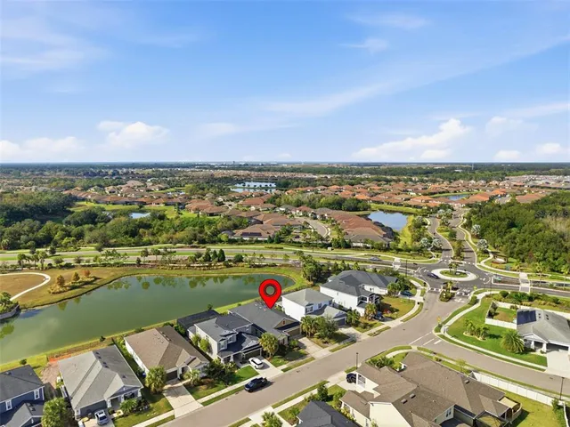 a view of a patio with couches chairs and a table and chairs under an umbrella with a yard
