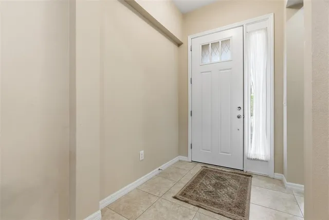 a view of a hallway with furniture and entryway