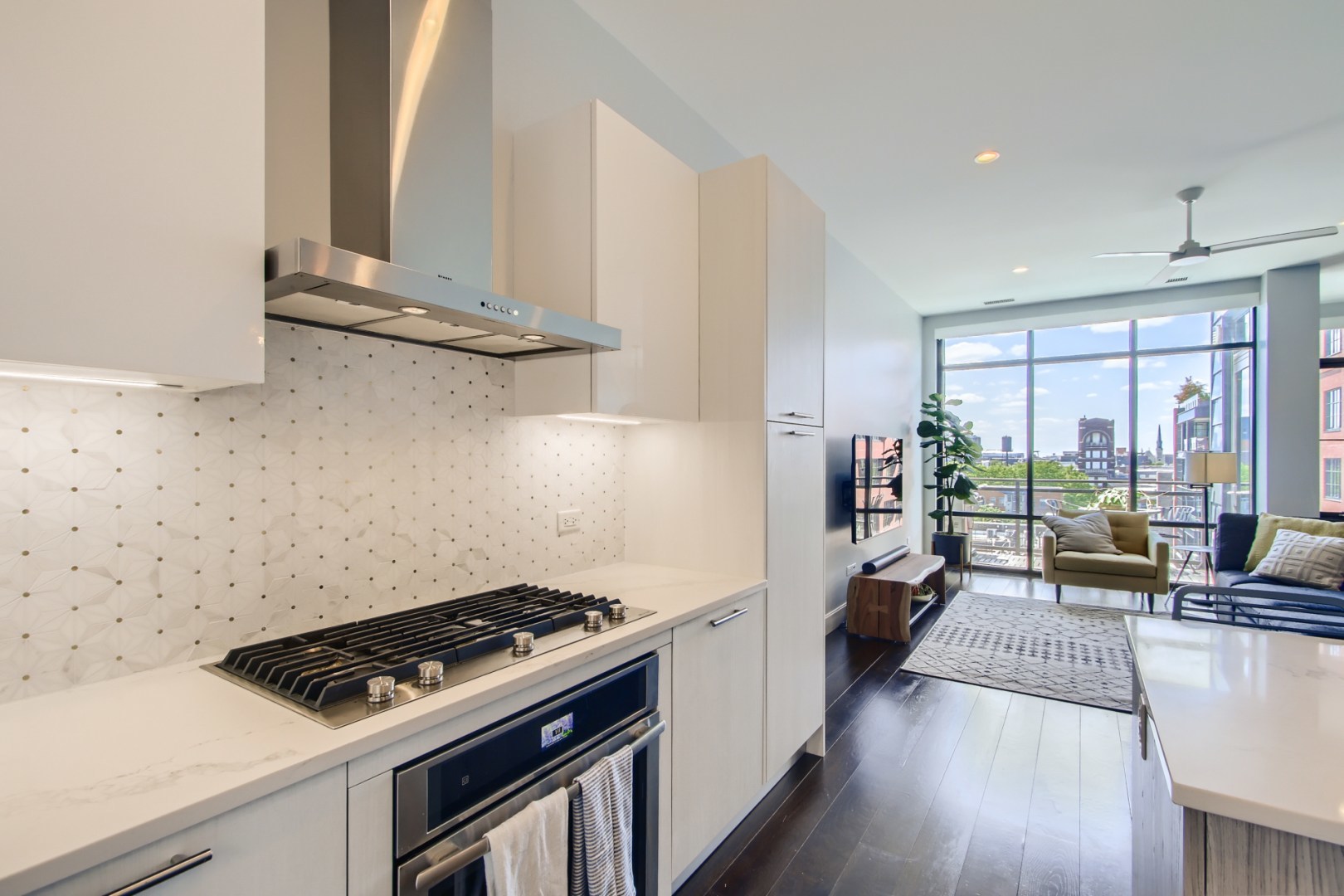 31 North Aberdeen Street, Unit PHS Chicago, IL 60607 - Photo 11 of 28 a kitchen with a stove and a wooden floor