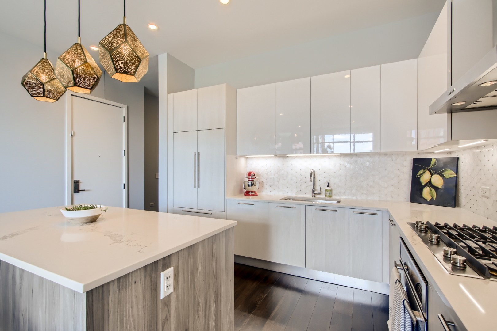 31 North Aberdeen Street, Unit PHS Chicago, IL 60607 - Photo 10 of 28 a kitchen with kitchen island white cabinets a sink a stove and refrigerator