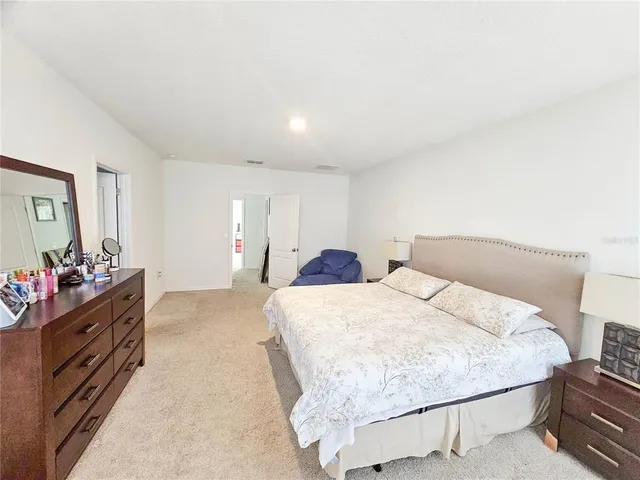 a bed room with a bed and a dresser