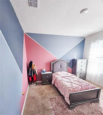 a bed sitting in a room with a table