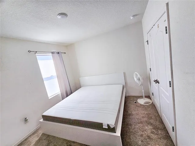 a bedroom with bed and a chandelier