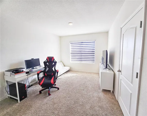 a bathroom with a granite countertop sink mirror vanity and toilet