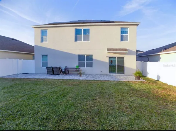 a view front of house with a yard and plants