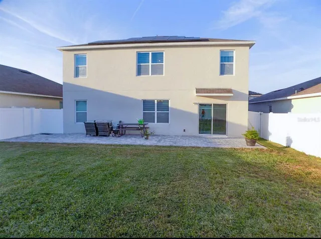 a view front of house with a yard and plants