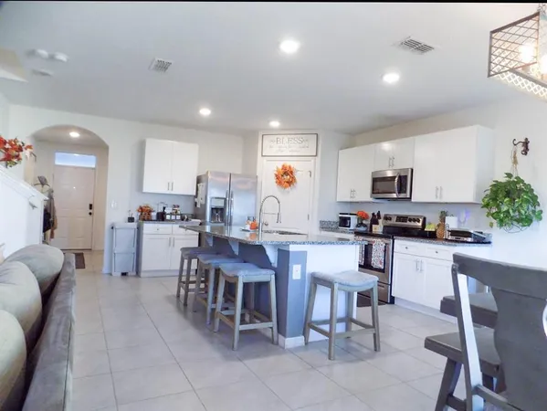 a kitchen with a dining table chairs and view kitchen