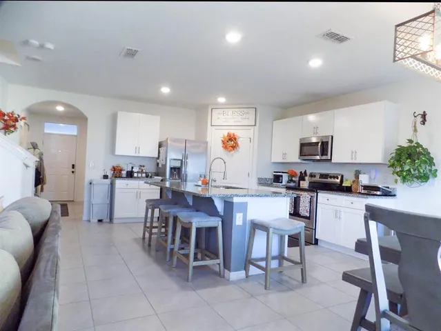 a kitchen with a dining table chairs and view kitchen