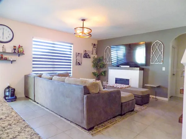 a living room with furniture and a chandelier