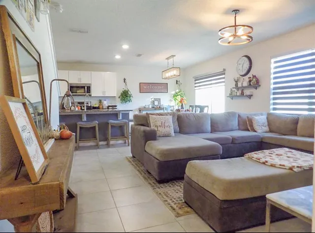 a living room with furniture and a chandelier