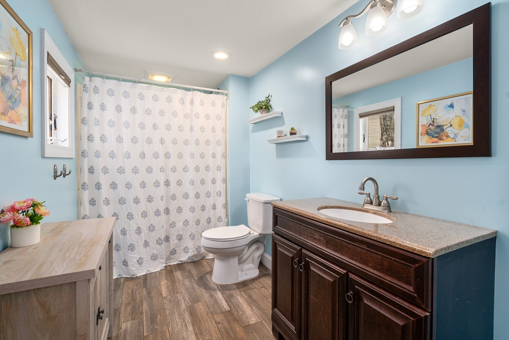 10 Cedar Street Hudson, MA 01749 - Photo 14 of 38 a bathroom with a sink a toilet and a mirror