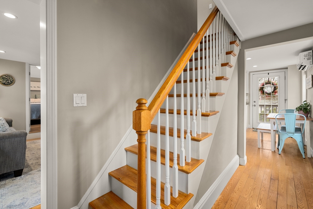 10 Cedar Street Hudson, MA 01749 - Photo 15 of 38 a view of staircase with lots of frames on wall and wooden floor