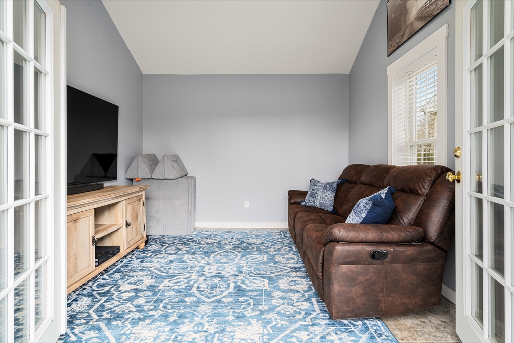 10 Cedar Street Hudson, MA 01749 - Photo 23 of 38 a living room with furniture and cabinets