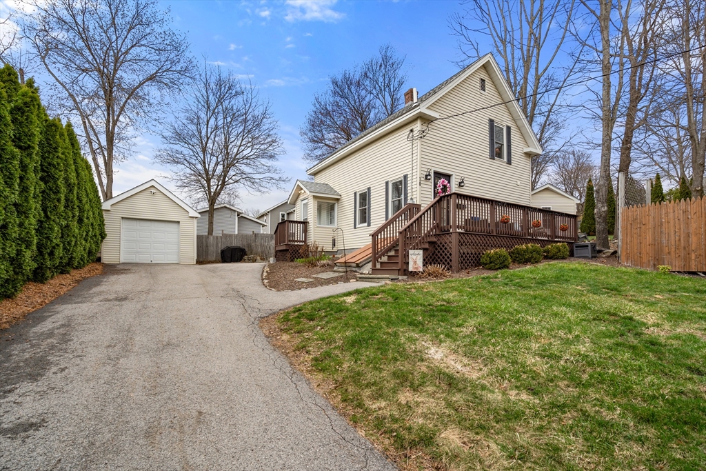 10 Cedar Street Hudson, MA 01749 - Photo 27 of 38 a view of a white house next to a yard with big trees